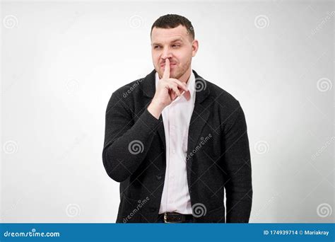 Man Saying Hush And Be Quiet With Finger On Lips Gesture Looking At