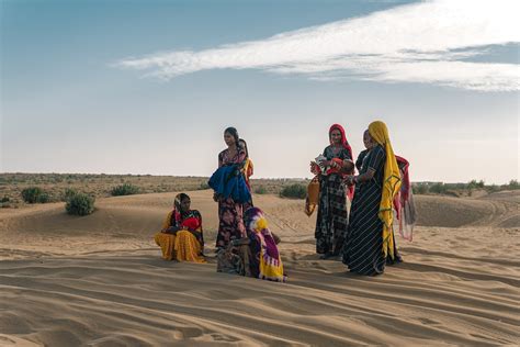 A Group of Women in Traditional Clothing on a Desert · Free Stock Photo