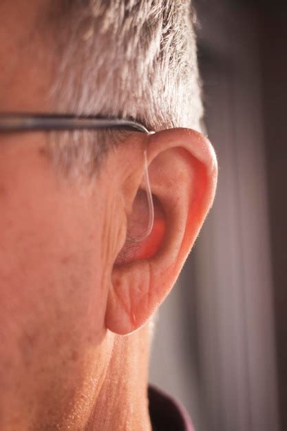 Premium Photo Close Up Of Man Wearing Hearing Aid