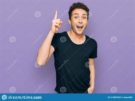 Young Handsome Man Wearing Casual Black T Shirt Pointing Finger Up With