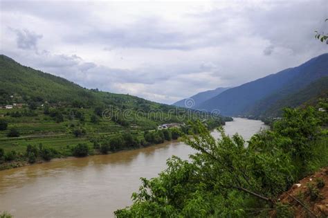 There Is A Quiet Lake At The Foot Of The Mountain With Dark Clouds