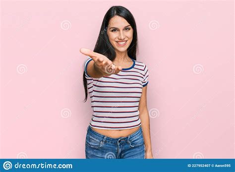 Young Hispanic Girl Wearing Casual Striped T Shirt Smiling Friendly