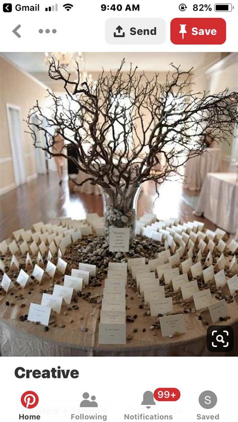 A Table With Place Cards On It And A Tree In The Center Surrounded By