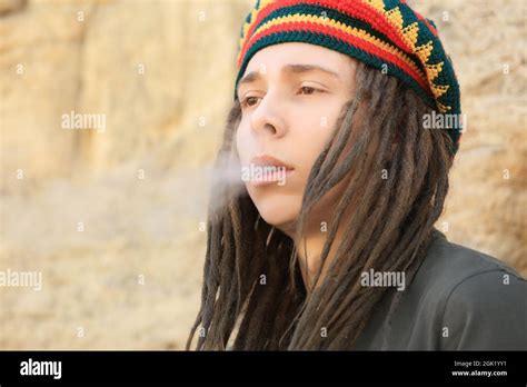 Young boy smoking weed on blurred background Stock Photo - Alamy