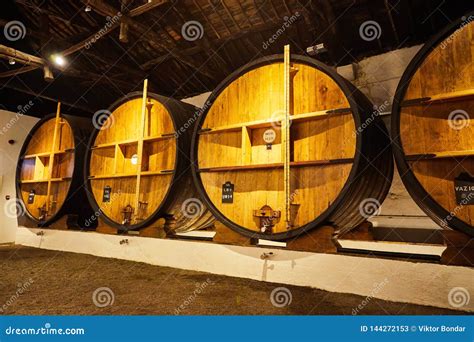 Old Aged Traditional Wooden Barrels With Wine In A Vault Lined Up In