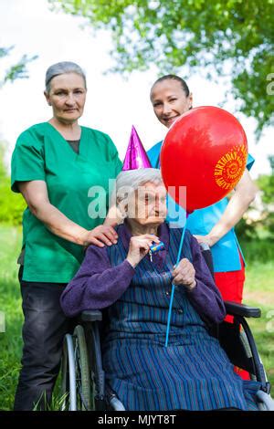 Eine Alte Gro Mutter Im Rollstuhl Feiert Geburtstag Mit Der Familie Und