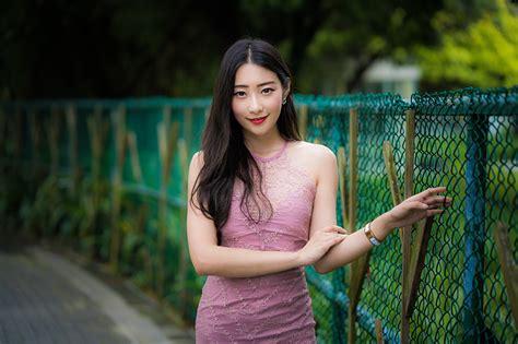 Pictures Brunette Girl Smile Bokeh Pose Female Asian Fence Hands