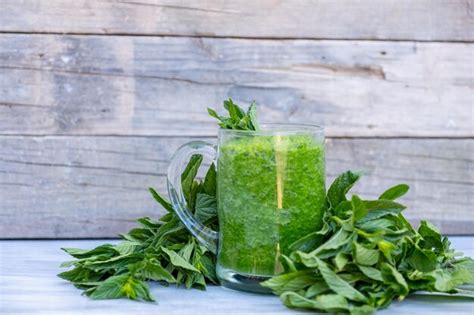 Premium Photo Green Smoothie Surrounded By Parsley And Spinach