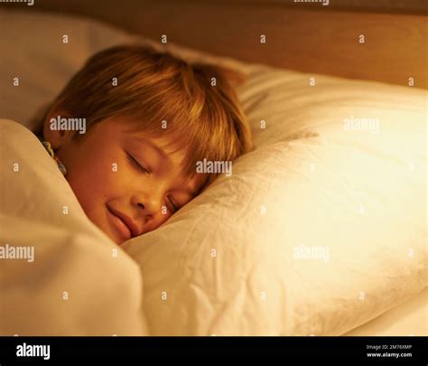 Dream A Happy Little Dream A Young Boy Sleeping In Bed Stock Photo Alamy