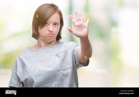 Young adult woman with down syndrome over isolated background doing ...