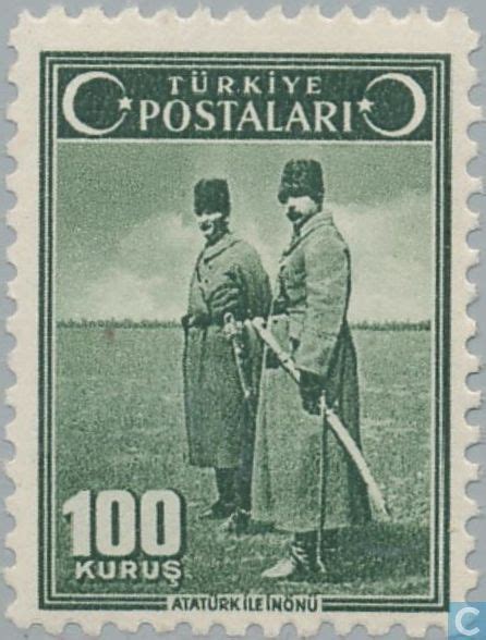 An Old Stamp With Two Men In Uniform Holding Baseball Bats And Standing