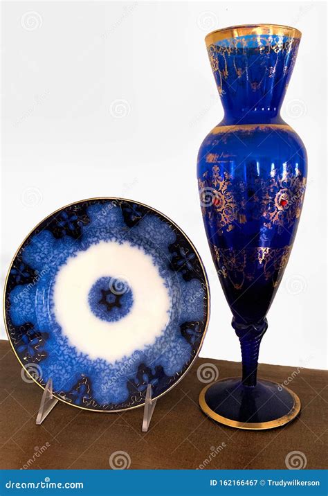 Antique Flow Blue Plate And Vintage Vase With Gold Trim Stock Image