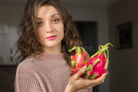 Young Girl Is Holding Two Fresh Ripe Organic Dragon Fruits Or Pitaya