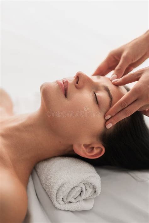 Relaxed Young Lady Lying On Massage Table During Beauty Procedure Stock