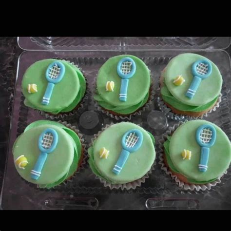 Six Cupcakes Decorated With Green Frosting And Blue Fondant Tennis Rackets