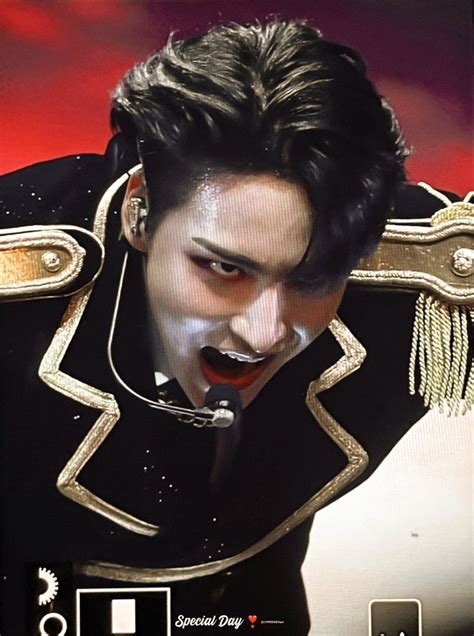 A Man With Black Hair And White Make Up On His Face