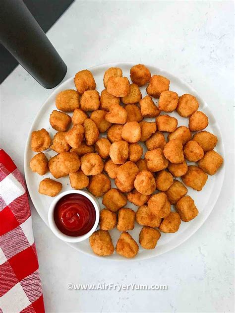 Tater Tots On A White Plate With Ketchup And A Red Checkered Napkin