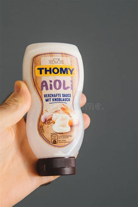 Hand Holding Delicious Thomy Aioli Sauce With Garlic Editorial Image