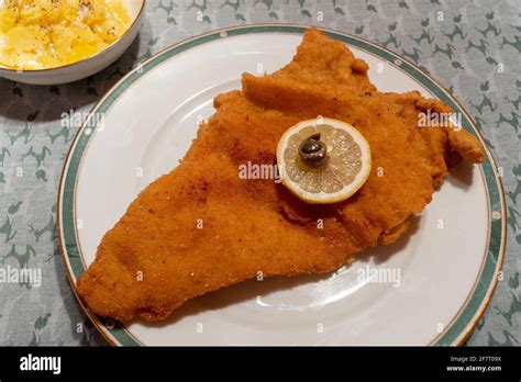 Wiener Schnitzel A Viennese Breaded Fried Veal Escalope With Potato Salad Garnished With A