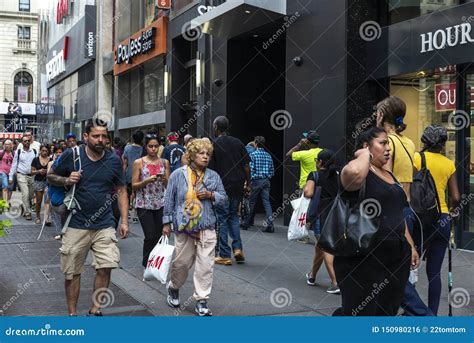 People Walking Down A Street With Shops In New York City Usa Editorial