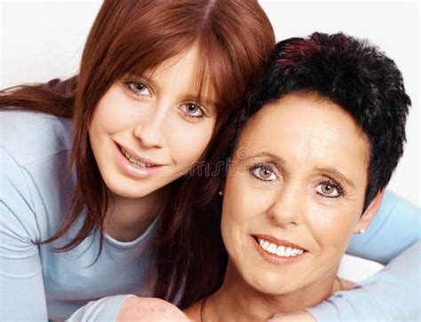 Mature Mother And Adult Daughter Hugging In The Park On A Summer Day