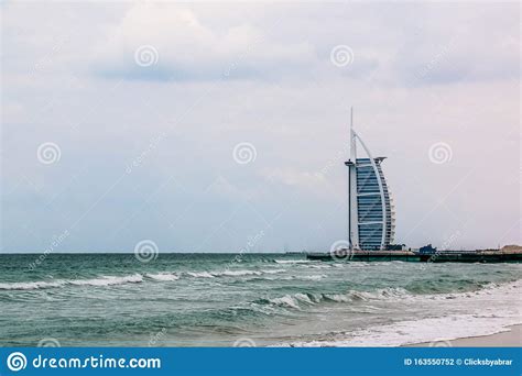 Waterfront View Of Burj Al Arab Under Cloudy Sky Seven Star Hotel A