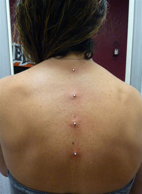 Back Dimple Piercing With Tattoo