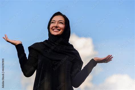 Beautiful middle eastern woman wait for rain. Stock Photo | Adobe Stock