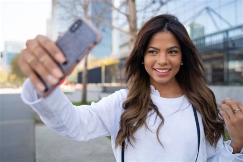 Premium Photo Portrait Of Young Woman Taking Selfies With Her Mophile