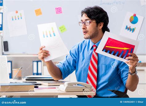 The Young Male Financial Manager Working In The Office Stock Image