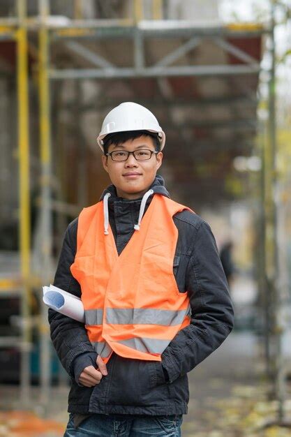 Premium Photo Portrait Of Engineer In Reflective Clothing Standing