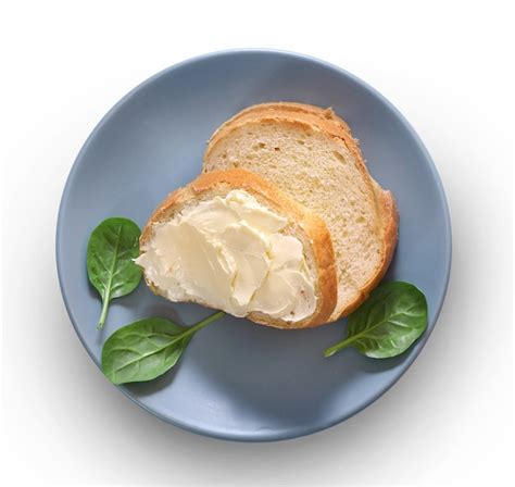 Premium Photo | Bread and butter on plate isolated on white