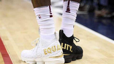 LeBron makes statement with shoes wearing 1 black shoe, 1 white shoe