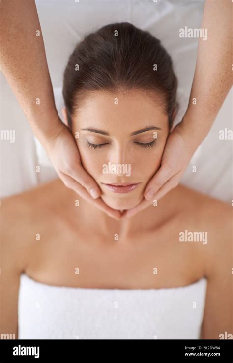 Beauty Treatment Shot Of A Young Woman Receiving A Face Massage Stock