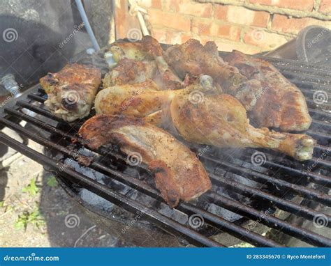 Corn Fed Chicken Thighs And Drumsticks With Outdoor Pork Belly Prepared On A Charcoal Grill