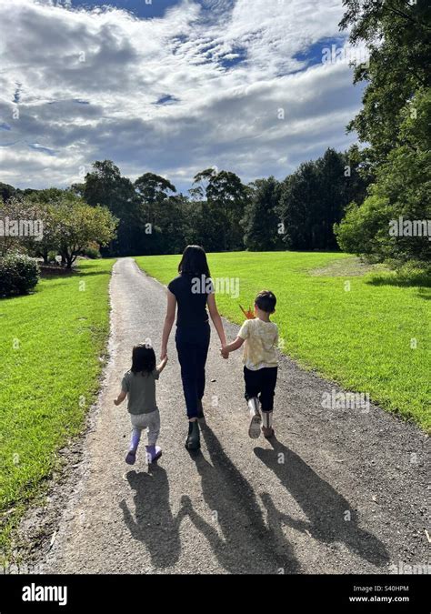 Young children holding hands walking Stock Photo - Alamy