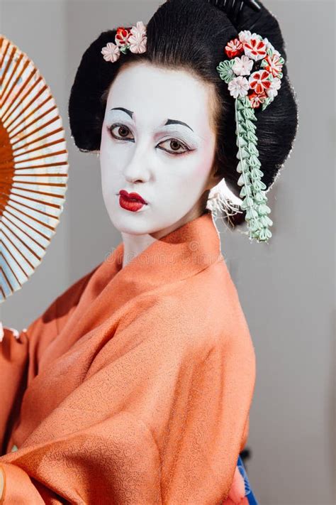 Woman In Geisha Makeup And A Traditional Japanese Kimono Studio