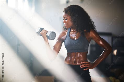 Fit African American Woman Lifting Iron In Home Gym Photos Adobe Stock