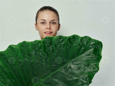 Pretty Woman Covers Her Body With Green Leaf Smile Light Background