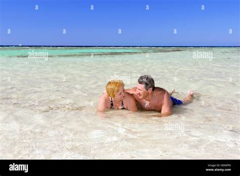Mature couple on the beach in the tropical resort Stock Photo - Alamy