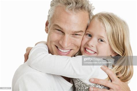 Portrait Of Father And Daughter Hugging Smiling Photo Getty Images