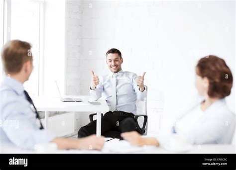 businessman showing thumbs up in office Stock Photo - Alamy