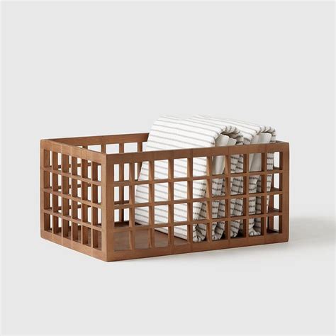 A Wooden Crate Filled With Lots Of White Towels