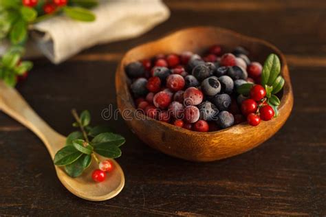 Frozen Cranberries And Blueberries In A Wooden Bowl Decorated With A