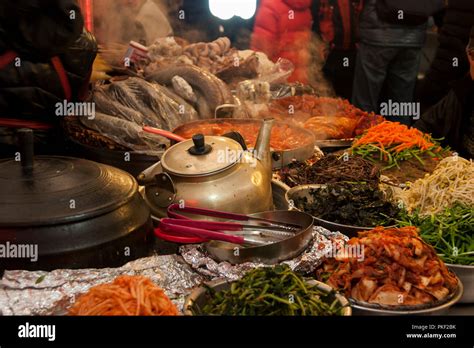 Traditional Korean food market with fresh kimchi, vegetables and meat. Outdoor fresh food market ...