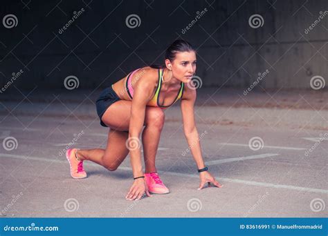 Woman Athlete In The Ready Set Go Position To Start Running Stock Image