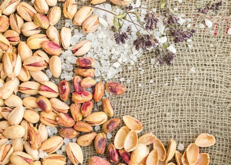 Pistachios In Shell And Peeled Pistachios With Salt And Dry Herbs Stock