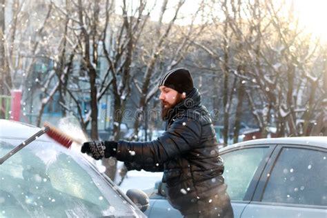 Man Cleans Snow From The Glass At The Car Stock Photo Image Of