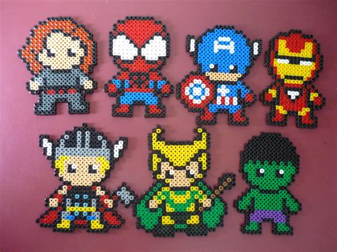 The Avengerss Perler Beads Are Displayed On A Pink Wall In Front Of A