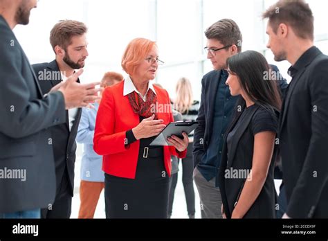 Large Group Of Young And Mature Delegates In Formalwear Walking Stock